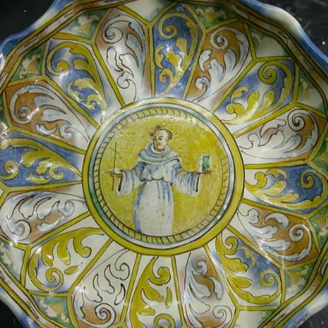 Restauro alzatina in maiolica con girali e clipeo centrale con figura di santo, fase dell'intervento; tipologia di restauro: mimetico antiquariale - Restoration riser in majolica with plant volutes and clypeus with central figure of a saint, step the intervention, type of restoration: invisible